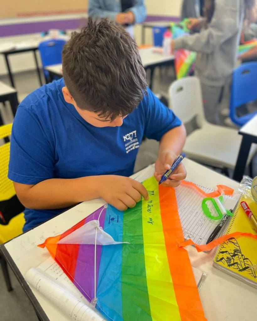 Boy writing on a kite for Kite Festival